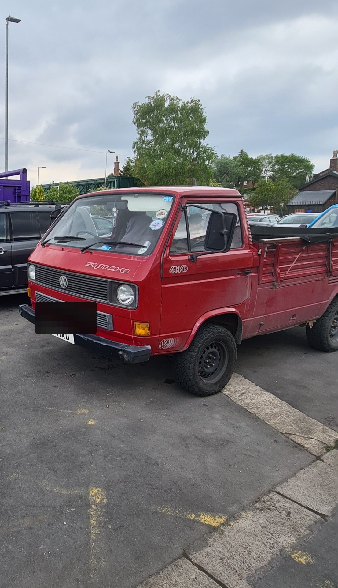 Red VW T3 Syncro 4WD pickup truck with chunky off-road tyres